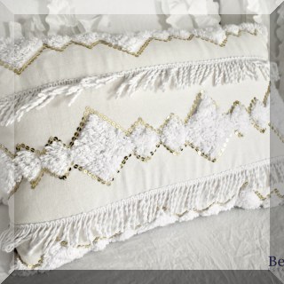 D48. Pair of white ruffled pillows with sequins.